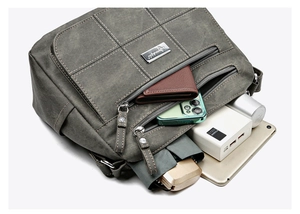 Detail of vintage grey leather crossbody bag showing multiple pockets and large capacity