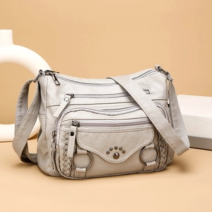 Light gray multi-layer soft leather crossbody bag with metal rivets and woven edges