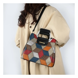 Detail view of stylish crossbody bag with 3D geometric patterns and embossed textures