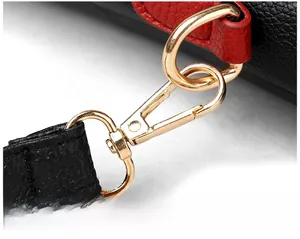 Detail of durable gold-plated lobster clasp on lychee-textured leather shoulder bag strap
