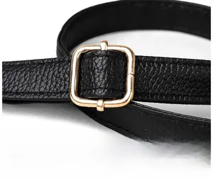 Detail of adjustable black litchi grain leather strap with gold metal buckle