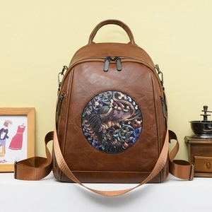 Vintage brown leather backpack with colorful elephant embroidery and multiple compartments