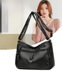 Detailed view of the black multi-pocket PU leather crossbody bag with silver hardware