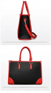 Détail du sac cabas rouge et noir avec cuir à grain litchi et boucles en métal doré
