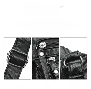 Detail of silver buckles and smooth black oil-wax leather on a stylish handbag
