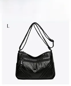 Detail of black multi-zippered crossbody bag in soft PU leather with adjustable strap