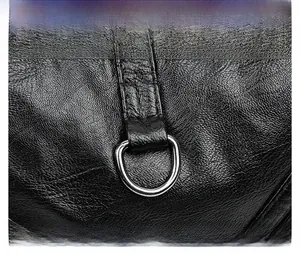 Detail shot of a black textured leather bag featuring a polished silver D-ring buckle