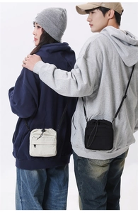 Nylon drawstring crossbody phone bag shown in beige and black on models for size comparison