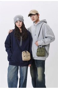 Models wearing khaki and olive nylon drawstring crossbody bags with adjustable straps