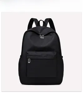 Detailed front view of black oxford backpack showing zippers and front pocket