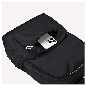 Close-up of front zipper pocket on black nylon backpack holding a smartphone