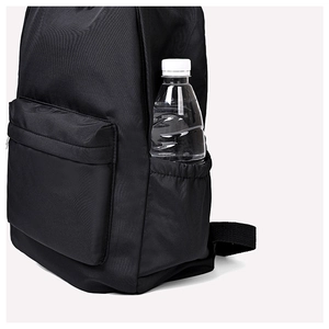 Close-up of the waterproof fabric and side pocket with a water bottle on a black backpack