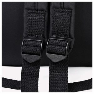 Detail of adjustable shoulder straps and durable plastic buckles on a black backpack