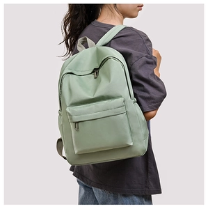 Close-up of lightweight light green oxford cloth backpack with smooth zipper detail