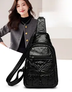 Detail of soft PU leather crossbody bag with heart ornament and adjustable strap