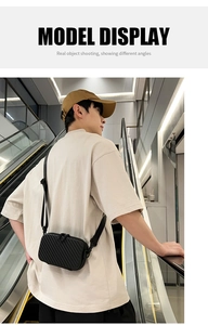 Detail of black hardshell crossbody bag with textured stripes shown on a model