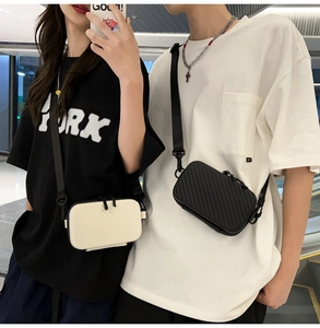 Dual view of textured hardshell mini crossbody bags in black and cream worn by models
