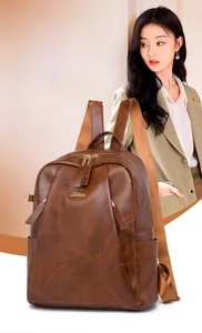 Detail view of large brown vintage PU leather backpack with gold zippers and side pockets