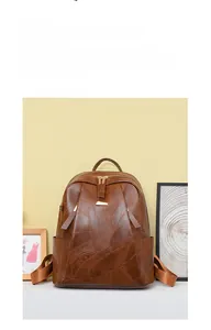 Detail of vintage brown PU leather backpack with decorative stitching and zip pulls
