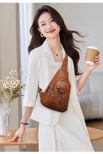 Brown vintage PU leather chest bag detail with heart-shaped metal trim and multi-zipper pockets