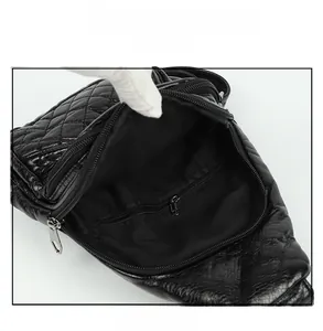 Internal view of black quilted PU leather sling bag showing the spacious fabric lining