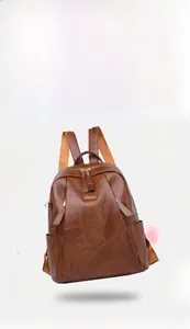 Detail of caramel vintage PU leather backpack showing 0.4KG weight and hardware