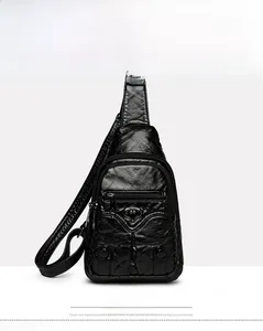 Front view detail of a black vintage PU leather chest bag with heart metal buckle