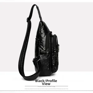 Close-up of black PU leather sling bag with multiple zippers and soft wrinkled texture