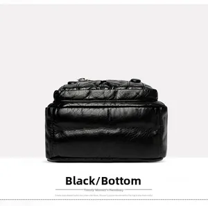 Detail view of the black PU leather crossbody bag base with protective metal studs