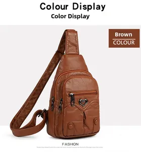Detail of brown litchi pattern faux leather chest bag with heart metal buckle