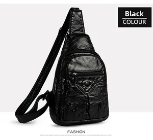 Detail of black PU leather chest bag featuring heart-shaped buckle and textured surface