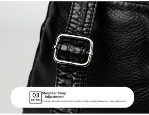 Detail of adjustable shoulder strap with silver metal buckle on black embossed leather bag