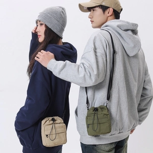 Versatile nylon crossbody phone bag with drawstring closure and front zipper pocket