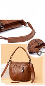 Close-up of brown pleated PU leather bucket bag with gunmetal hardware and sturdy handle