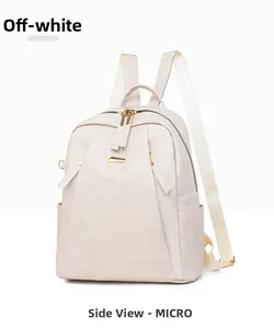 Detail view of cream vintage PU leather backpack with side pockets and golden hardware