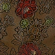 Detailed view of the vintage red peony pattern printed on the bronze fabric of this handbag