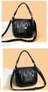 Detail view of black soft PU leather bucket bag with pleated design and metal zipper pocket