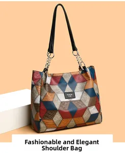 Detail of multi-color geometric patchwork tote bag with pebbled leather and silver chain