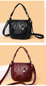 Detail view of soft PU leather shoulder bags in black and wine red with pleated design