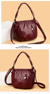 Detailed view of wine red PU leather bucket bag with heart zipper and wrinkled texture