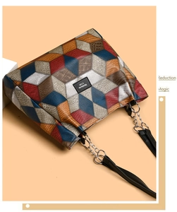 Detail of multi-color geometric 3D pattern tote bag with silver chain strap and brand logo