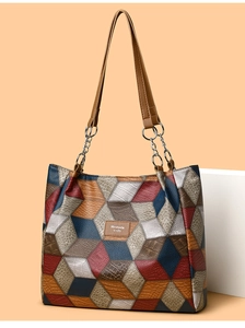 Close-up of geometric diamond pattern and metallic chain link on the large tote bag