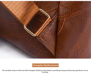 Detail of triangular reinforced stitching on brown leather backpack with gold metal buckle