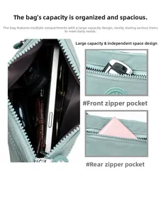 Minzgrüne Nylon-Umhängetasche mit mehreren Reißverschlussfächern und viel Stauraum im Detail