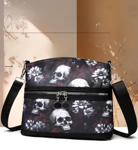 Detail of the skull and floral pattern on the waterproof nylon crossbody bag with dual zippers