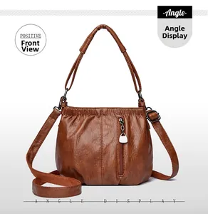 Front detail of brown PU leather bucket bag showing pleated texture and zipper