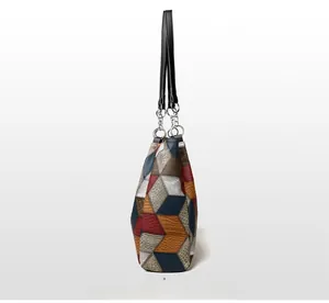Detail view of colorful geometric patchwork tote bag with high-quality pebbled texture