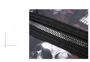 Detail of smooth metal zipper and double-stitching on skull print shoulder bag
