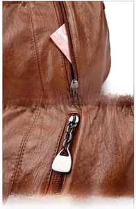 Close-up of vintage brown PU leather bag showing smooth front zipper and metal puller