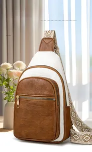 Detail of retro contrast crossbody bag with textured leather and ethnic strap